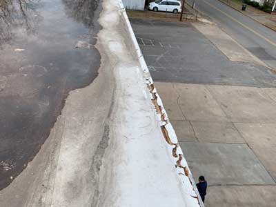 Flat roof damage due to weather and aging