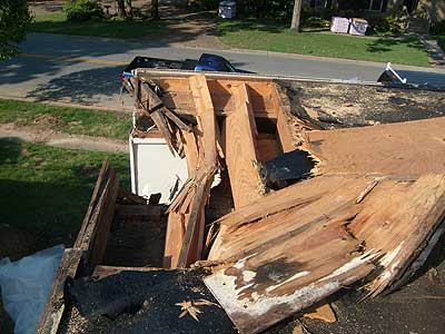 Residential roof damage from fallen tree