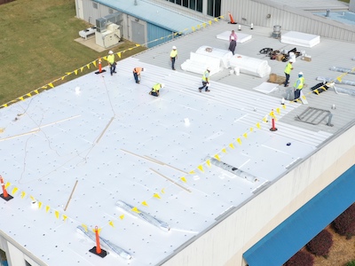 Fraley team working to lay decking before applying the TPO membrane